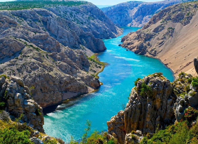 A canyon with a turquoise river. 1