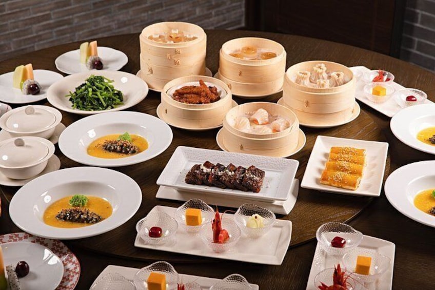 A variety of dishes and food items on a table, including plates, bowls, and a steamer. 1