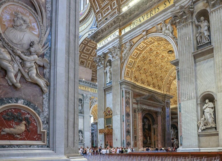 An ornate church interior with detailed sculptures and golden domes. 2