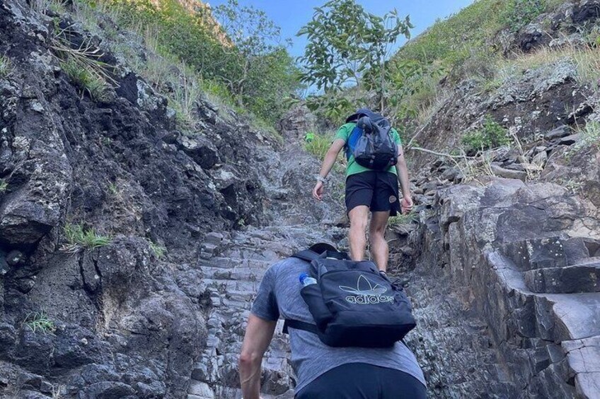 Two hikers on a rocky trail with one person leading and another following. 2