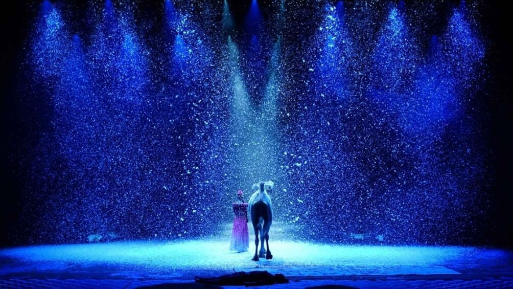 A person standing in a water fountain with water jets. 5