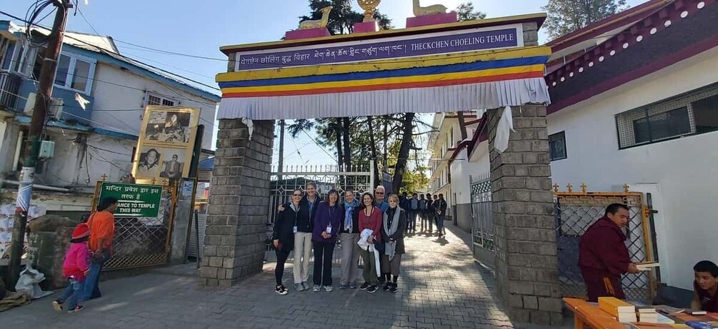 A group of people standing in front of Thekkchen Choeling Temple entrance. 3