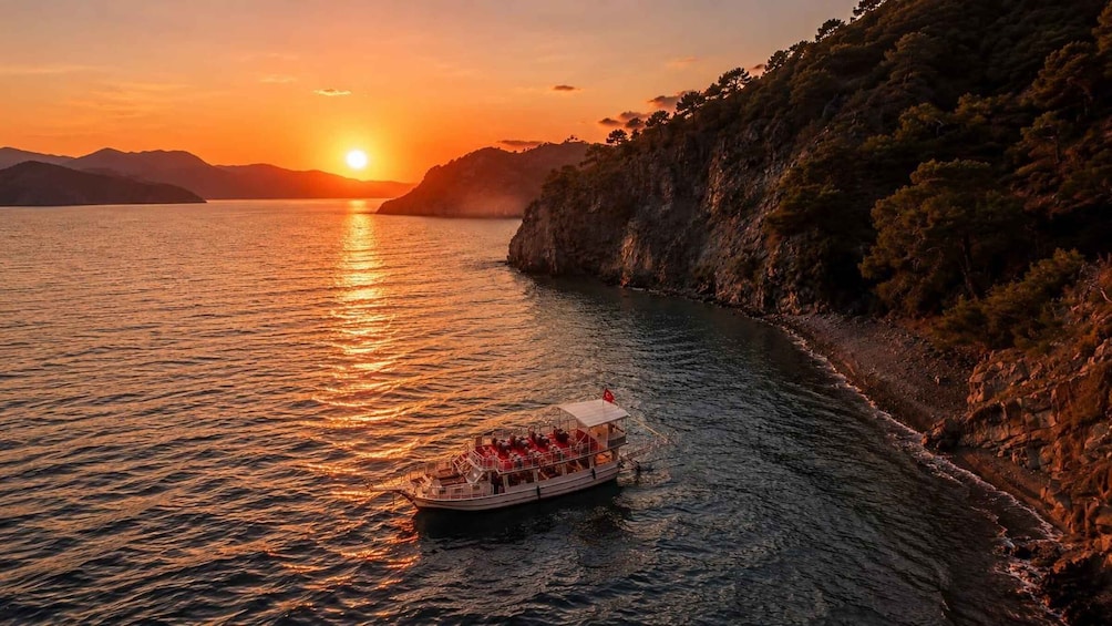 A boat with passengers on a calm river at sunset. 1