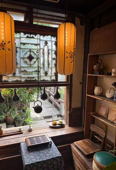A traditional interior with wooden furniture, a window with decorative lattice, hanging lanterns, and a view of a garden. 3
