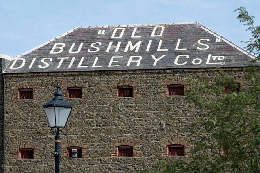 A historic building with the sign 'Old Bushmills Distillery Co. Ltd.' 2
