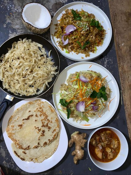 A meal with rice, vegetables, and a side of curry. 5