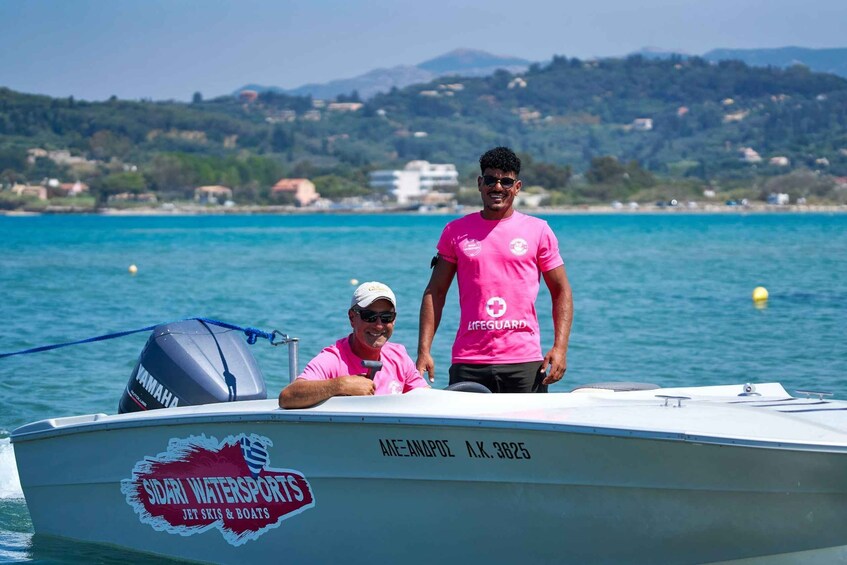 Two people on a boat with a logo for Sidari Watersports. 5