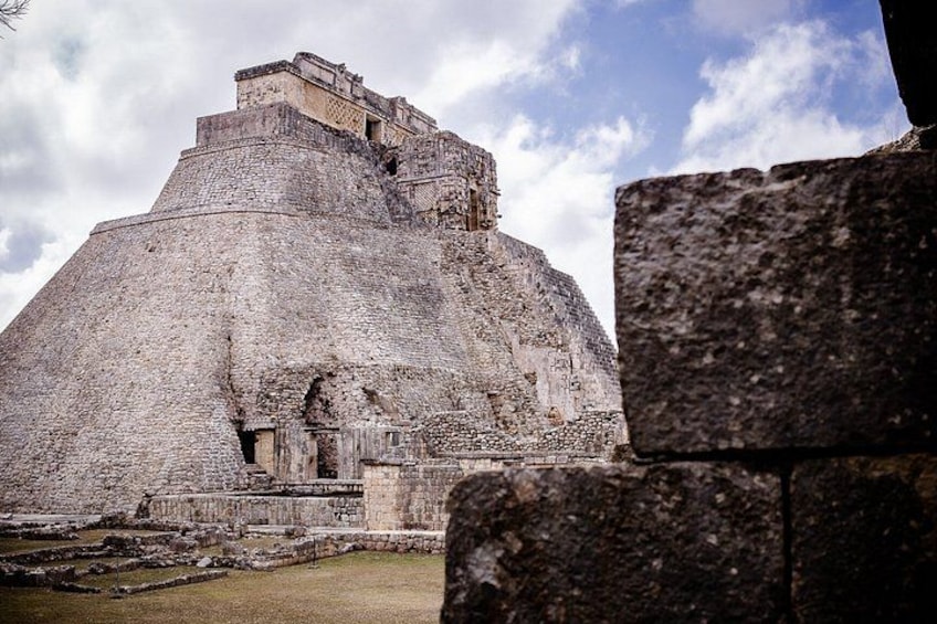A large ancient pyramid with a flat top and a smaller structure on top. 4