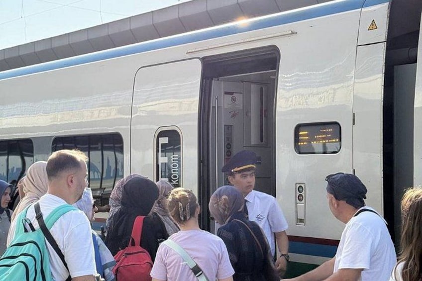 A train with passengers boarding. 3
