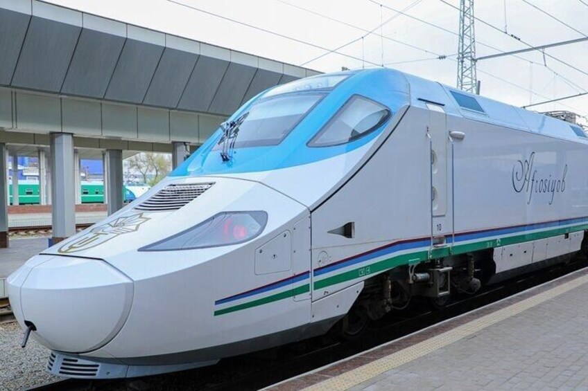 A high-speed train at a station platform. 1