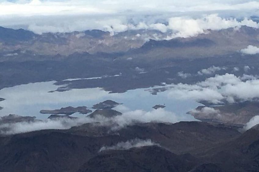 A mountainous landscape with lakes and clouds. 2