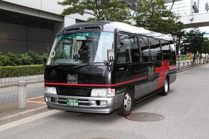 A black and red bus with the number 10-04 parked on a city street. 5