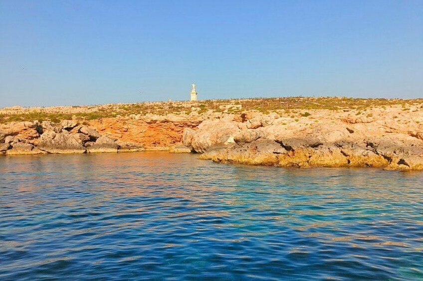 A rocky coastline with a lighthouse in the distance. 4
