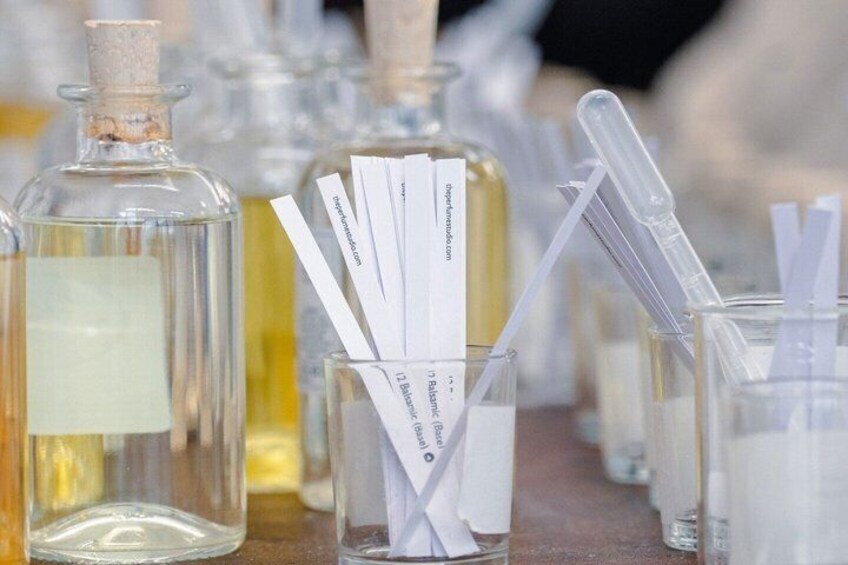 Glass bottles with labels and test tubes with white straws. 1