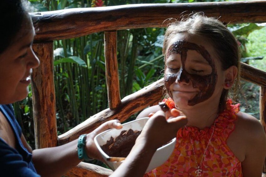 A person applying a substance to another person's face. 2