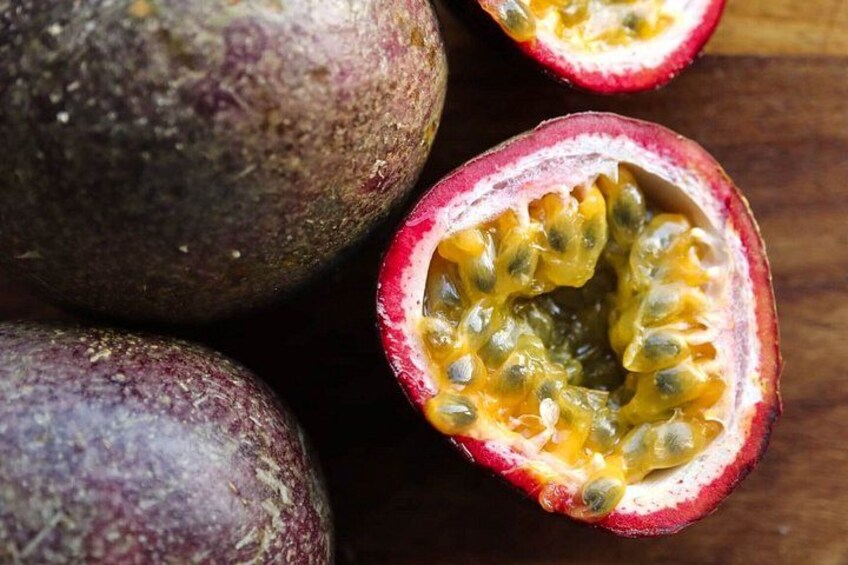 Passion fruit halves with a wooden background. 2