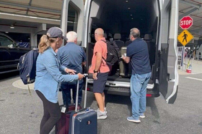 People boarding a bus with luggage. 3