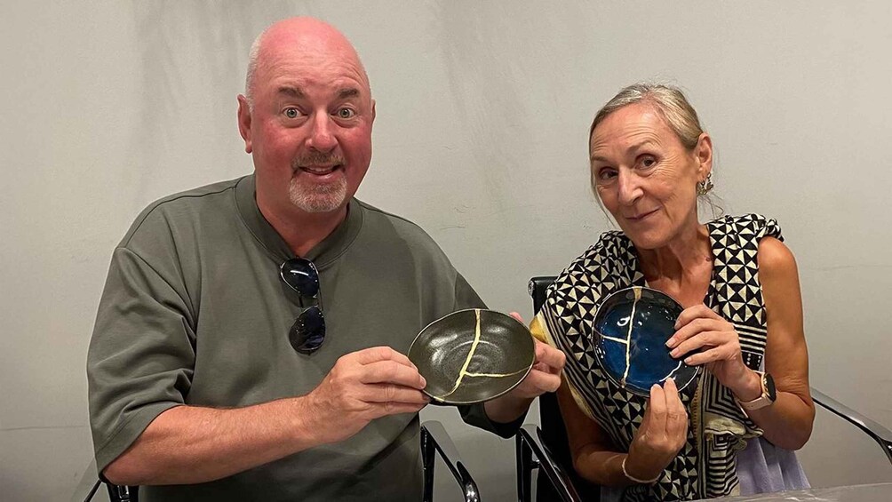 Two people holding ceramic plates. 3