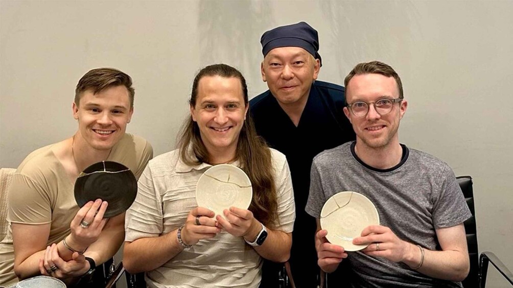 Four people holding circular objects. 5