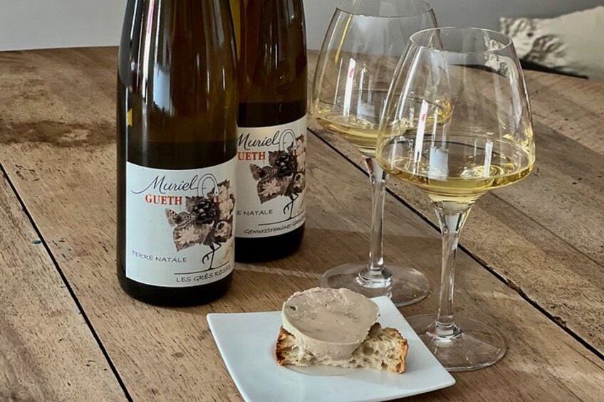 Two bottles of wine and two glasses on a wooden table. 4