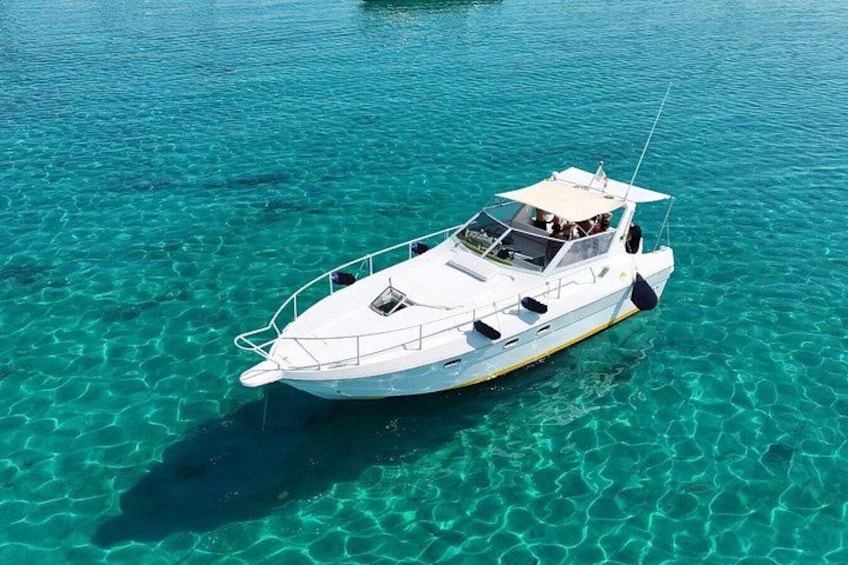 A white boat on clear turquoise water. 1