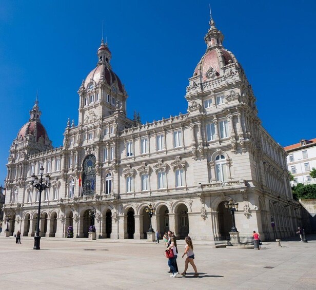A grand historic building with domed roofs and ornate architecture. 1