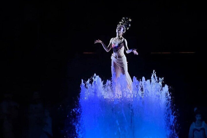 A person standing on a platform with water splashing around them. 5