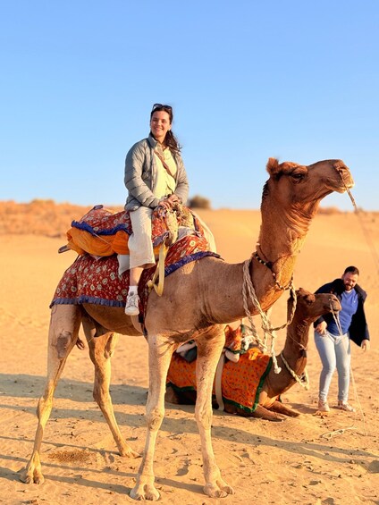 A person riding a camel in a desert. 5