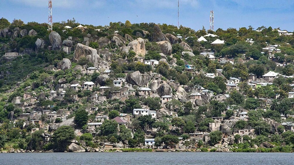 A coastal village with houses built on rocky terrain, overlooking the sea. 1