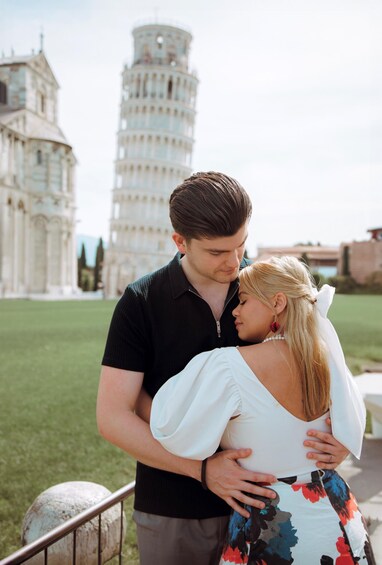 A couple embracing in front of the Leaning Tower of Pisa. 4