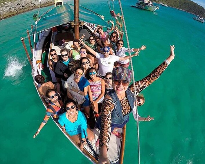 A group of people on a boat with turquoise water. 3