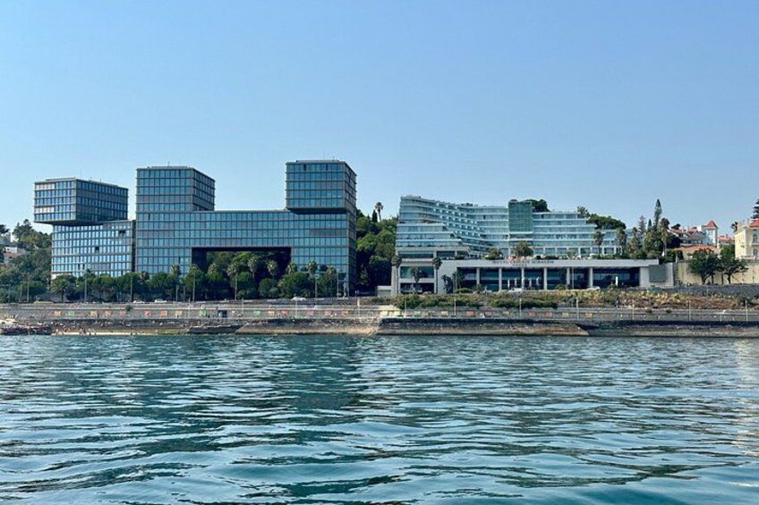 A modern building complex by the water with reflective glass windows. 2