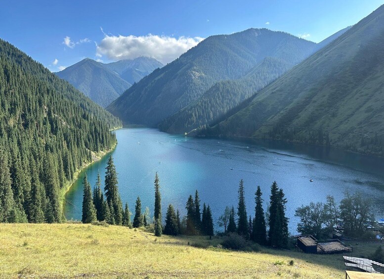 A lake surrounded by mountains and coniferous trees. 1