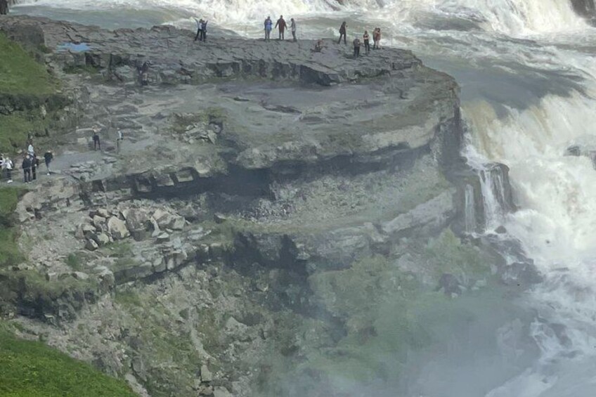 A rocky cliff with a waterfall. 1