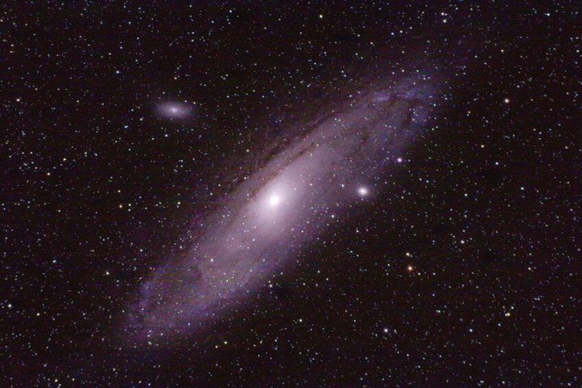 A galaxy with a bright core and spiral arms, surrounded by numerous stars. 2