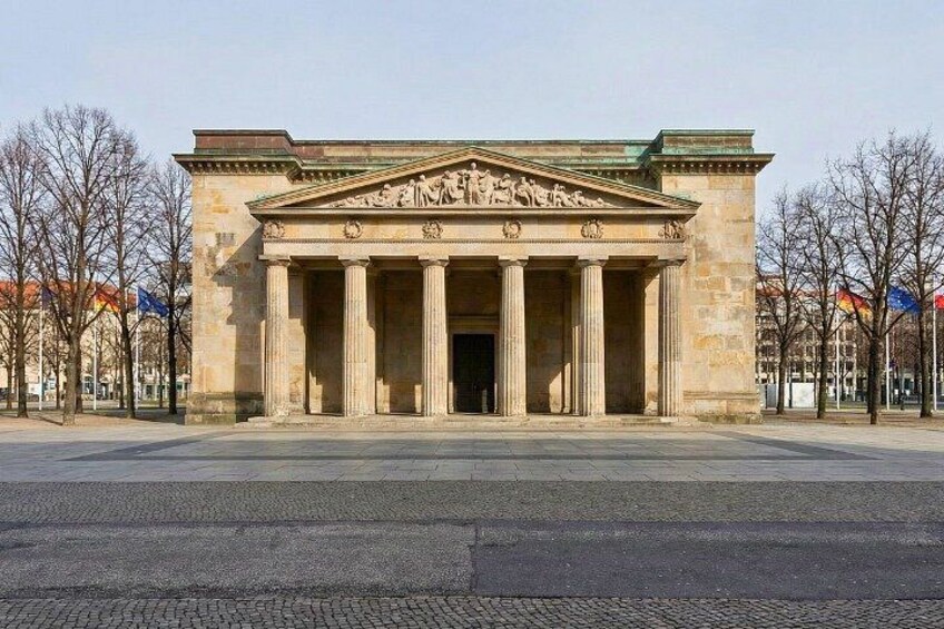 A neoclassical building with columns and a pediment. 5
