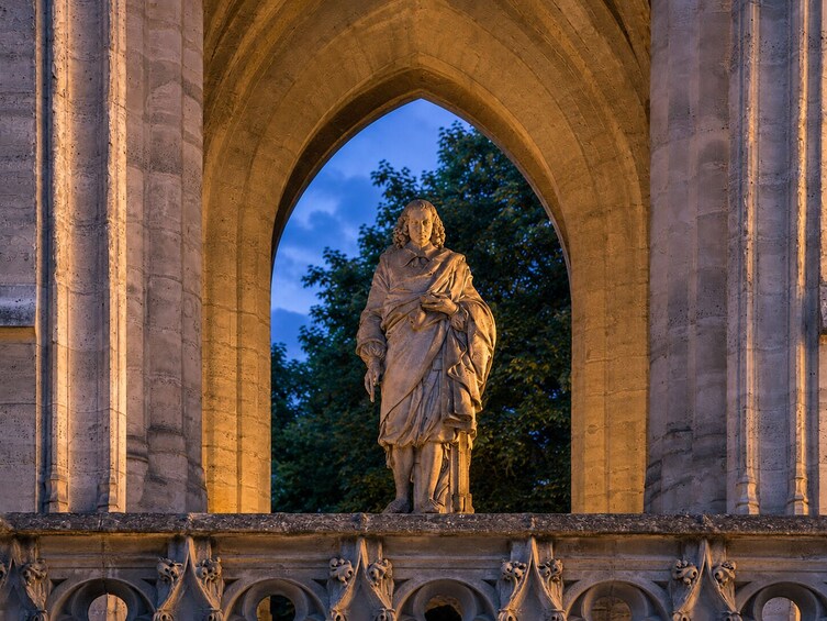 A statue within an arched structure, surrounded by ornate architectural details. 4