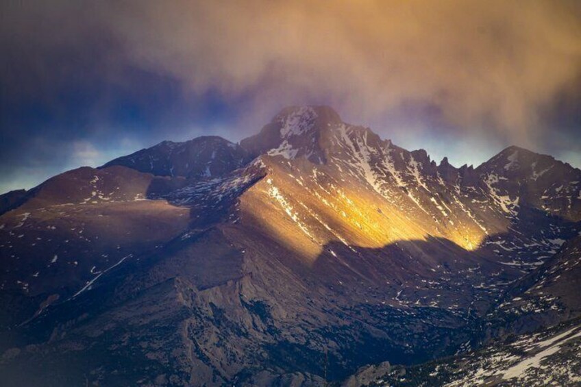 A mountain range with snow-capped peaks and a valley. 4