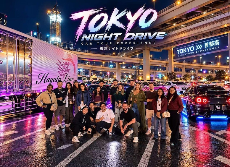 A group of people posing in front of a Tokyo Night Drive car tour experience advertisement. 4