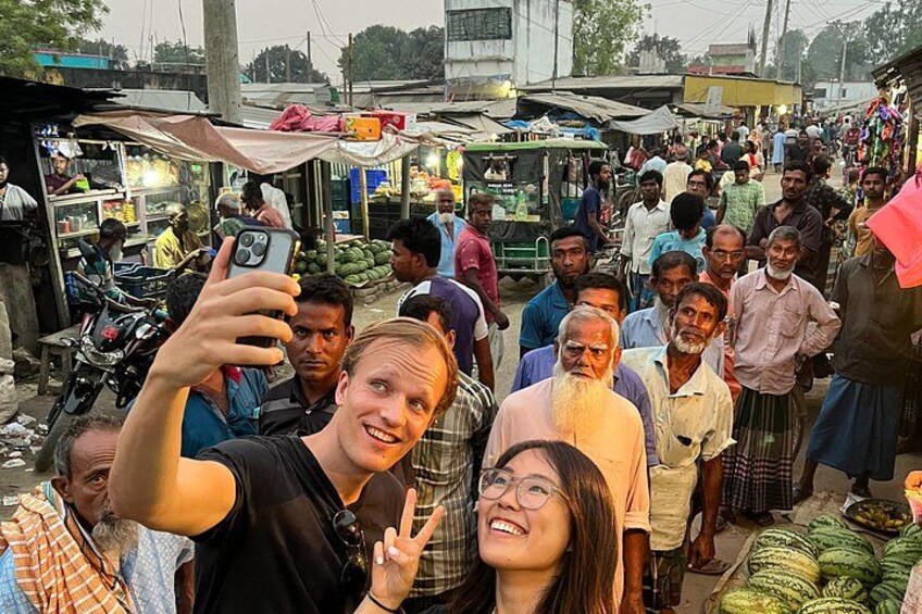A crowded market with people and stalls. 4