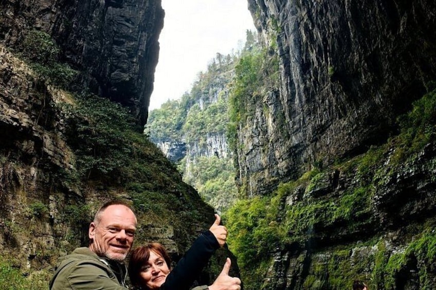 A canyon with steep rock walls and lush greenery. 5