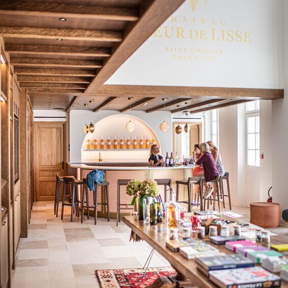 A wine tasting room with wooden beams, a bar area, and a large wine bottle display. 2