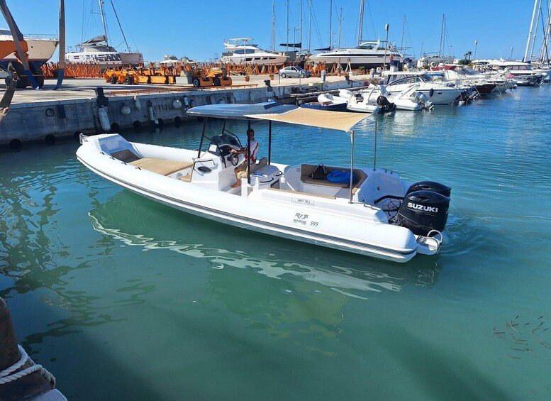 A marina with several boats docked, including a white motorboat with a Suzuki outboard motor. 4