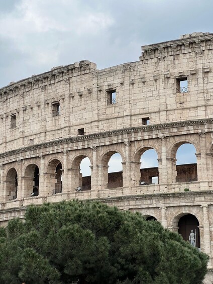 An ancient stone structure with multiple arches and a statue. 5
