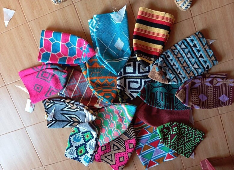 A collection of colorful woven textiles with various geometric patterns. 2