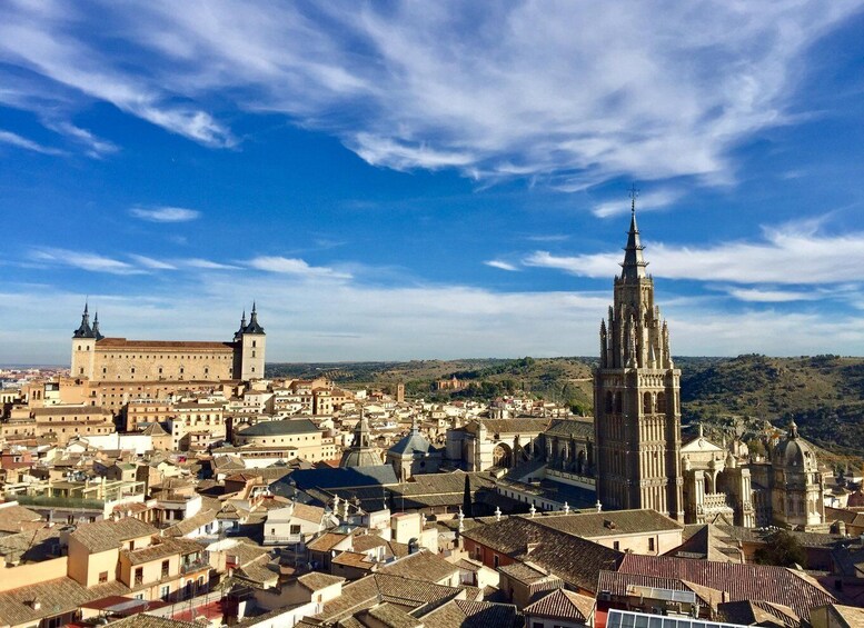 A cityscape with a prominent cathedral and a large historic building. 3