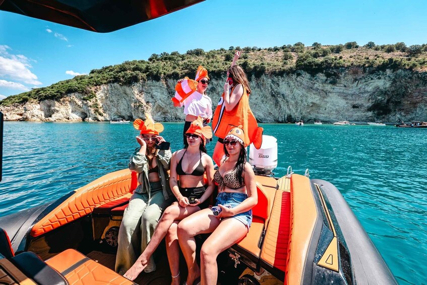 A group of people on a boat with cliffs in the background. 3