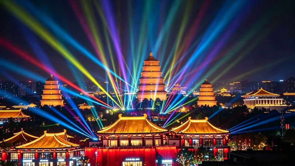 A night view of traditional Chinese architecture with pagodas and illuminated by colorful laser beams. 1
