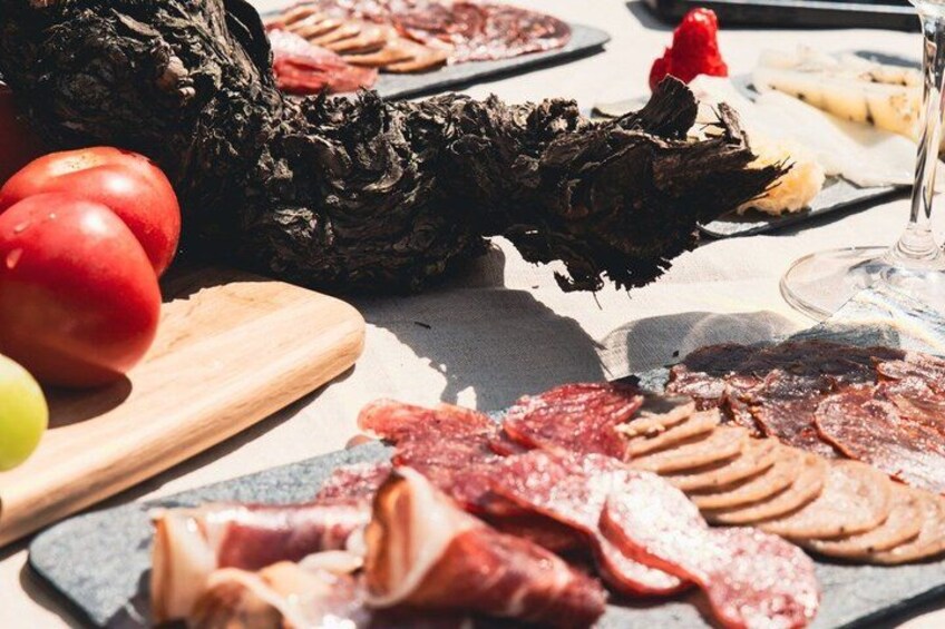 A charcuterie board with various meats, cheese, and fruits. 3