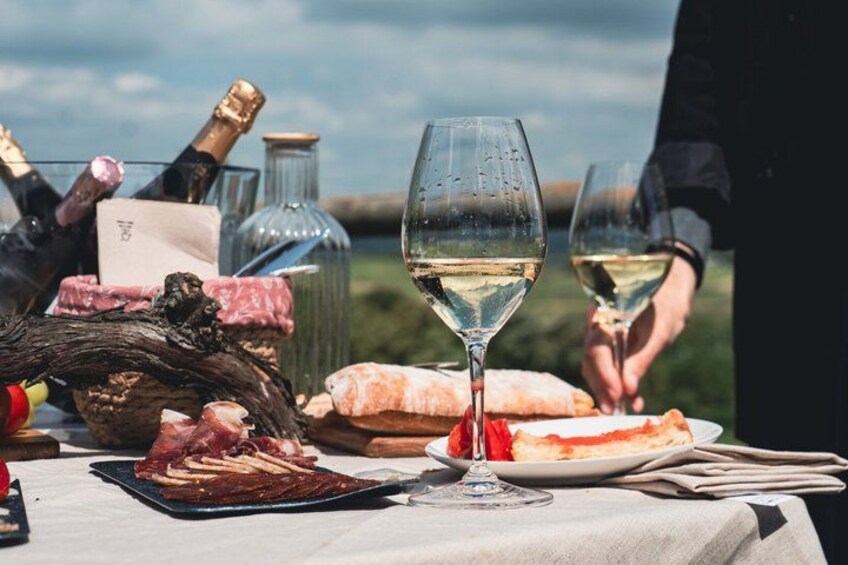 A table with food, wine, and a bottle. 4